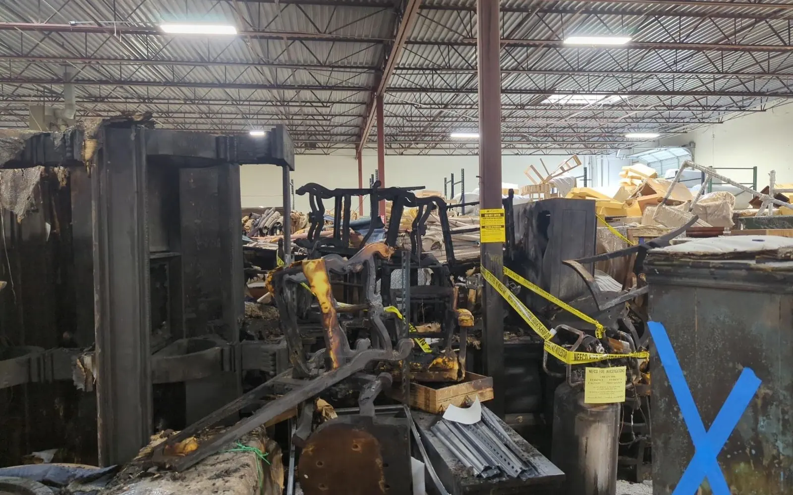Machinery and furnishings recorded item by item across a damaged warehouse floor