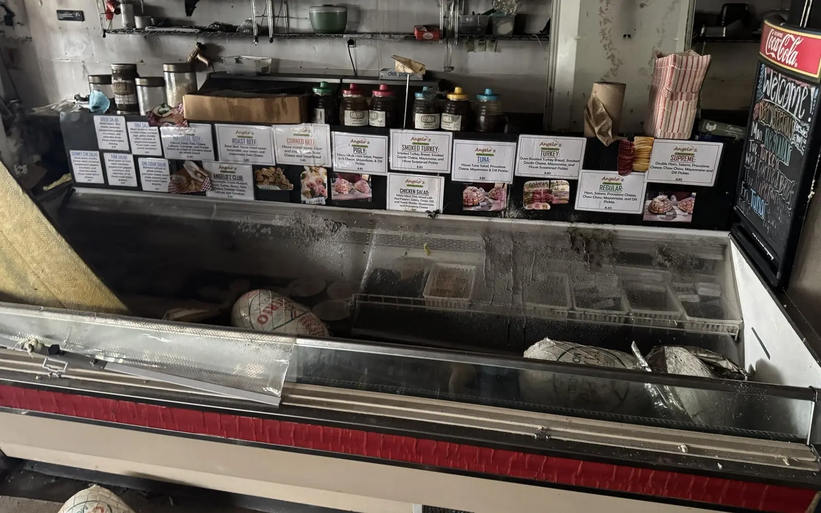 Smoke and fire damaged retail display case with product still on the shelves
